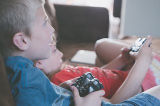 two kids holding video game controllers