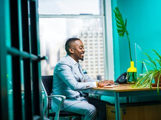 black man typing on computer