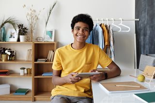 young black teen at a desk