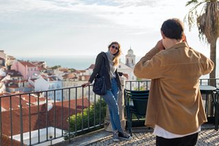 woman posing for a picture in a foreign country