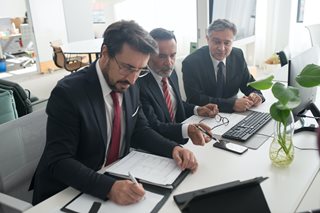 three older man doing banking