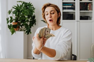 woman with a handful of cash