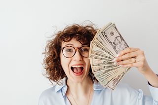 woman with a fan of money
