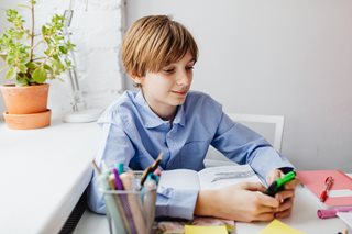young boy holding a calculator