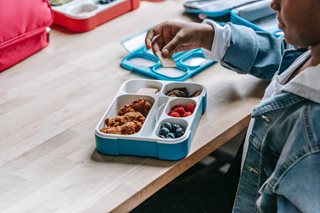 kid eating out of lunch box