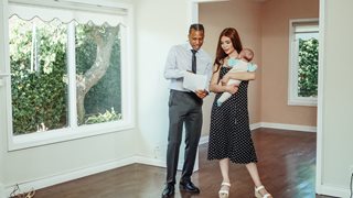 real estate agent and woman holding a baby