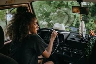 black woman driving a car
