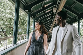 man and woman walking and holding hands