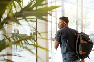 man with backpack walking away