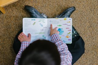 boy looking at notebook