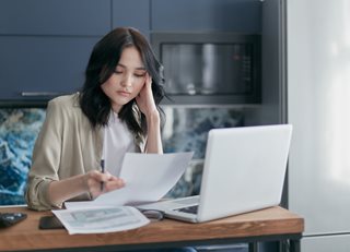 sad woman looking at paper