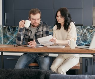 woman showing a shocked man a budget