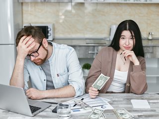 man and woman frustrated while working on budget
