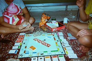 two kids playing monopoly