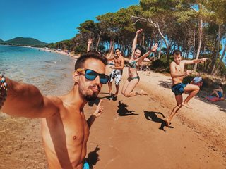 group of friends on the beach celebrating