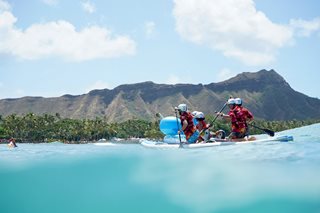 group of people on boat paddling