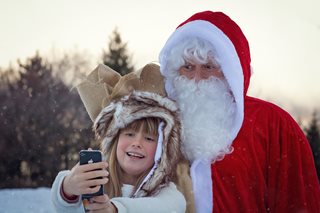 santa and young girl on phone