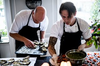 two chefs cooking food