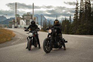 two people riding motorcycles