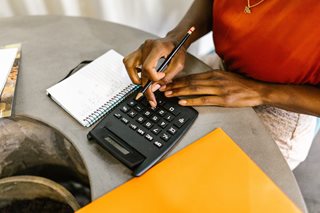 woman with calculator and paper