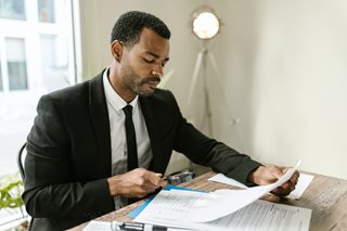 black man looking at documents