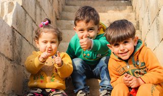 three small children on stairs