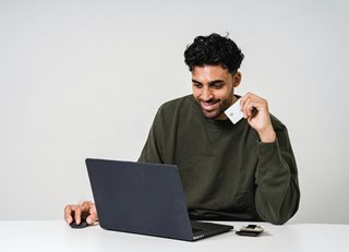 man with credit card and laptop
