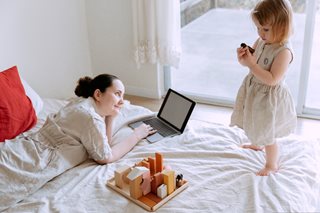 small girl with woman playing a game