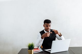 black man talking on a laptop call