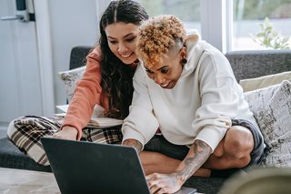 two women excited looking at a laptop