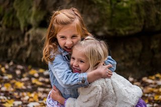 two young girls hugging and smiling