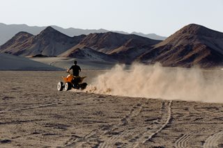 man riding an ATV in dirt