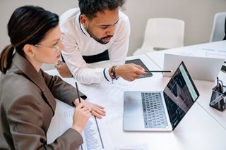 man and woman working on a laptop